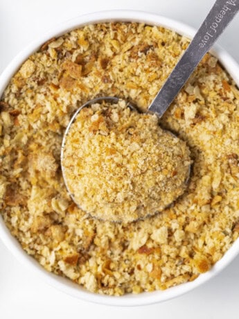 Homemade breadcrumbs in a bowl with a measuring spoon.