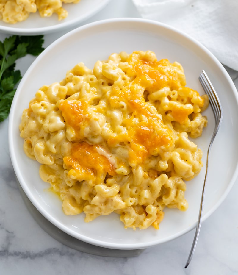 Baked Mac and Cheese on a white plate with a fork on the side.