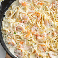A skillet of Shrimp Alfredo with Fettucine pasta.