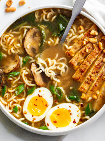 Homemade Ramen in a soup bowl with chicken, mushrooms, Bok Choy, and soft boiled eggs.