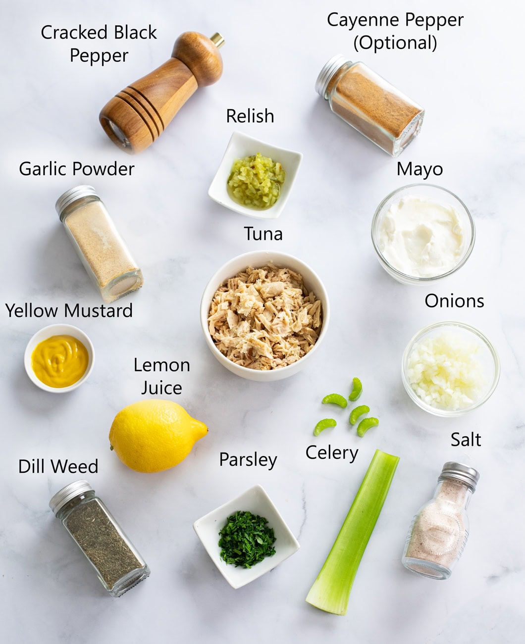 Ingredients for Tuna Salad on a white surface with labels.