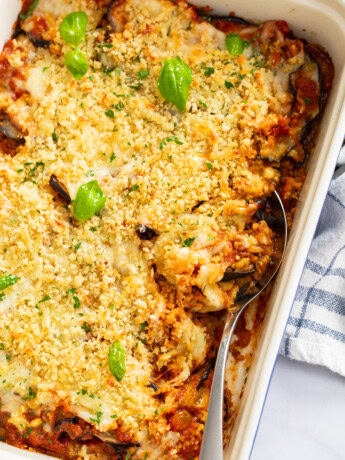 Eggplant Casserole in a baking dish with a spoon on the side.
